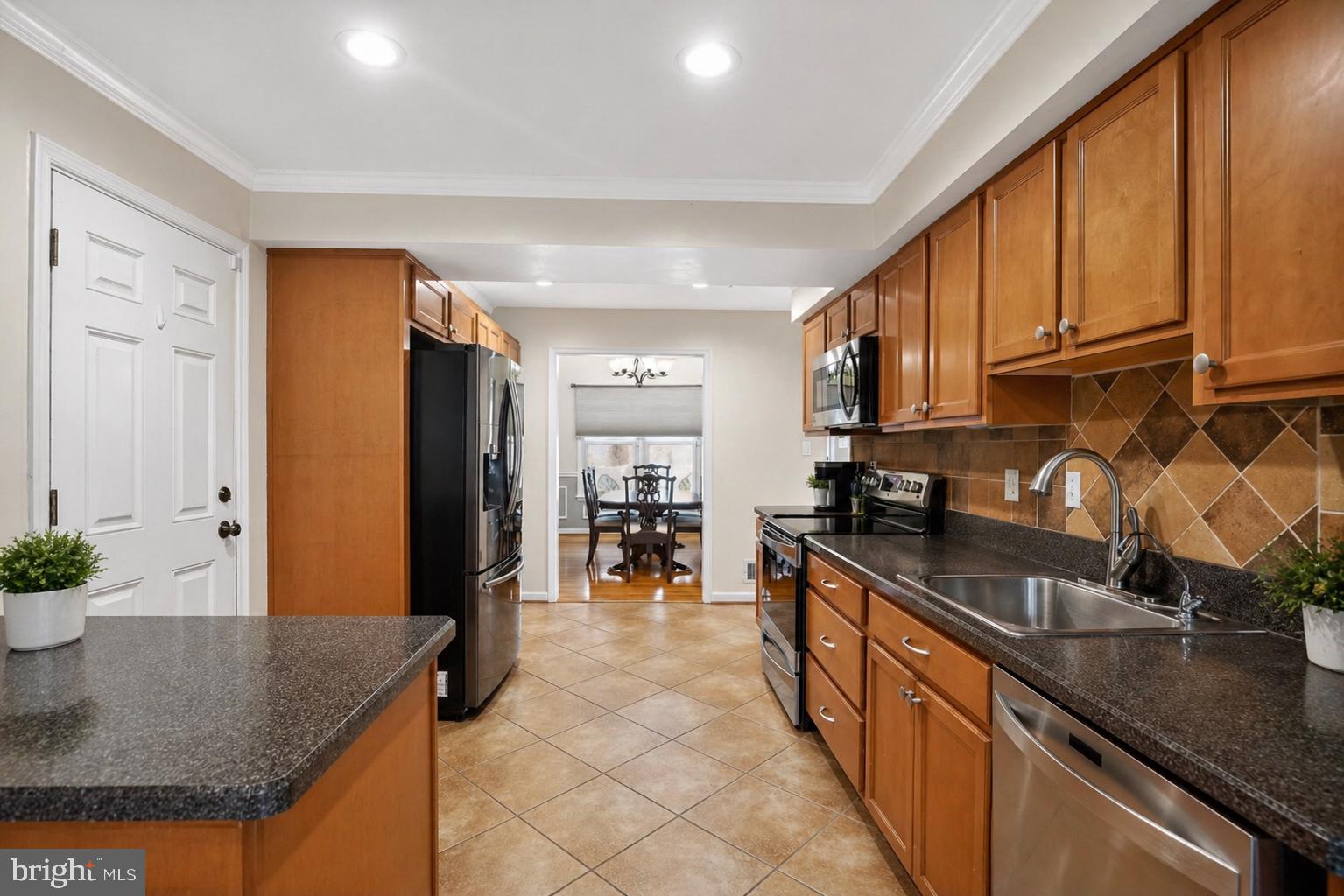8021 Clark Station Road Severn, MD 21144 - Photo 6 of 35 Modern kitchen with warm wood tones.