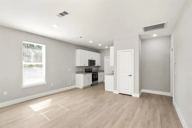 a view of kitchen with wooden floor and electronic appliances