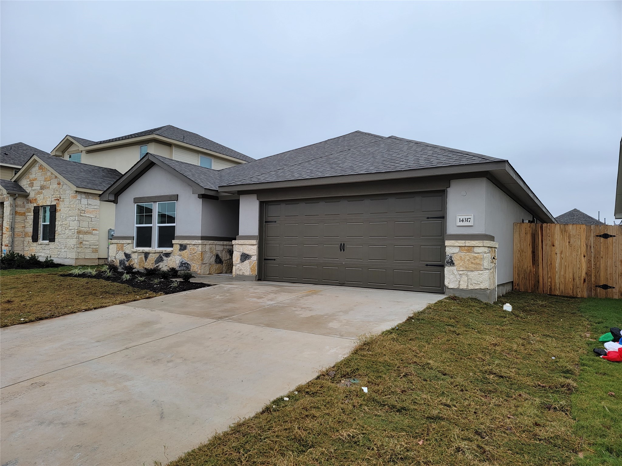14317 Bryce Lane Manor, TX 78653 - Photo 2 of 26 a front view of a house with a yard and garage