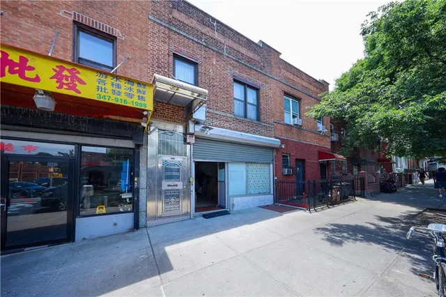 a view of a building with retail shops and traffic signal