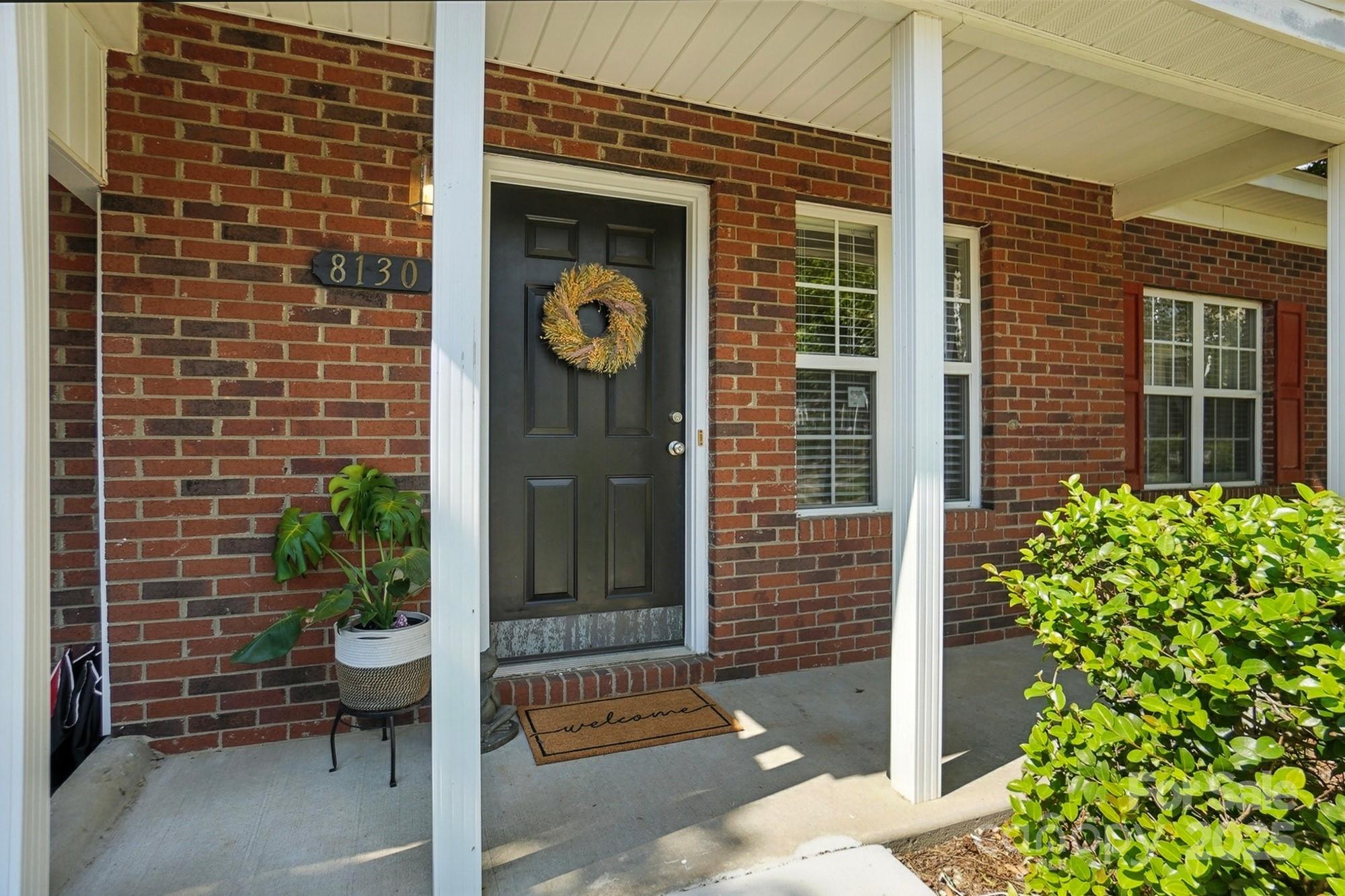 a view of a door and brick walls