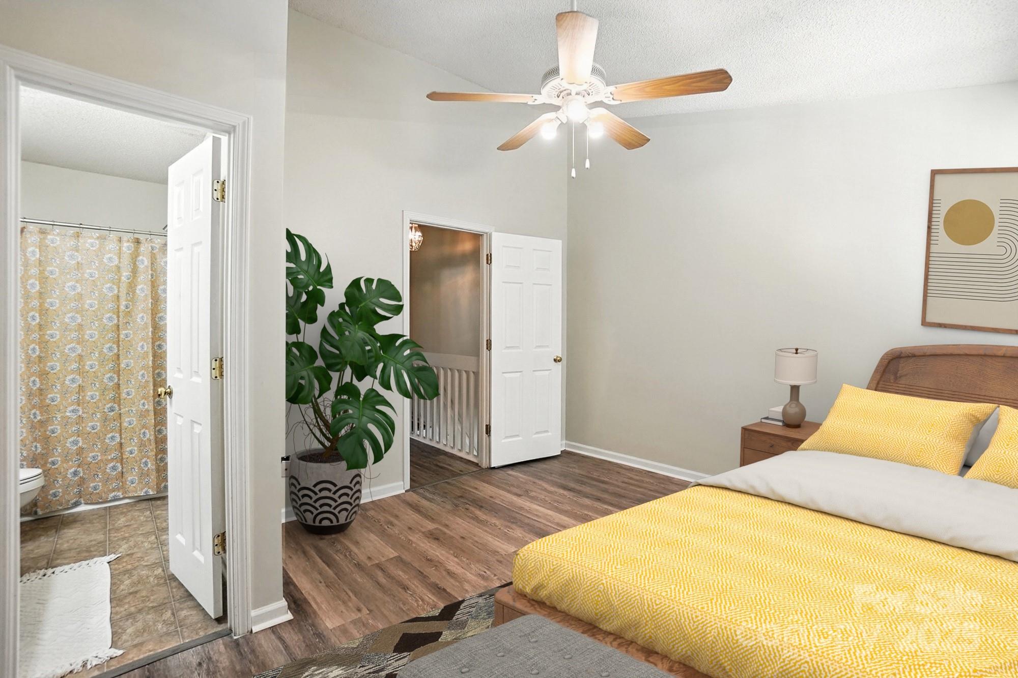 8130 Rudolph Road Charlotte, NC 28216 - Photo 14 of 36 a bedroom with a bed and a potted plant