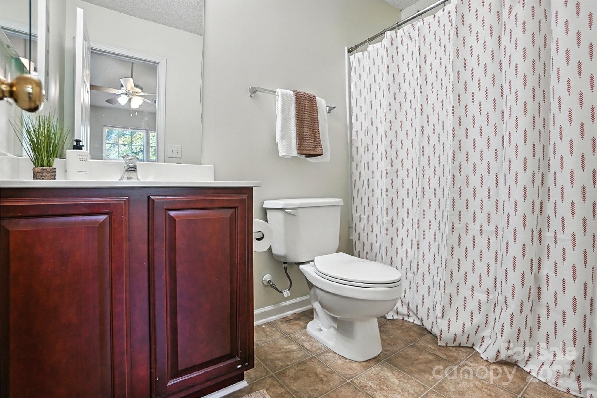 8130 Rudolph Road Charlotte, NC 28216 - Photo 18 of 36 a bathroom with a toilet sink and mirror