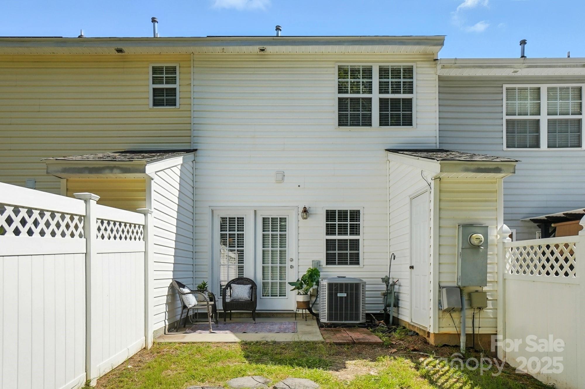 8130 Rudolph Road Charlotte, NC 28216 - Photo 21 of 36 a view of a patio with table and chairs and potted plants
