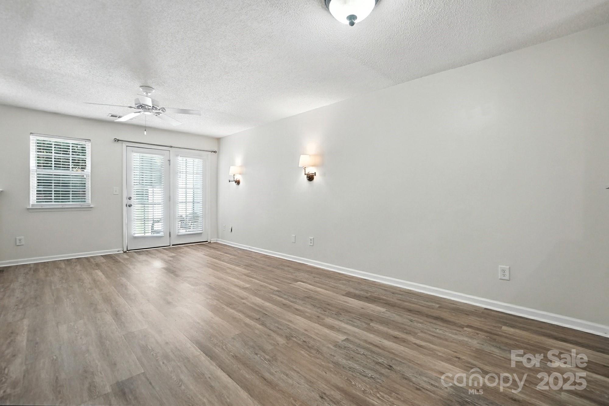 8130 Rudolph Road Charlotte, NC 28216 - Photo 28 of 36 an empty room with wooden floor and windows