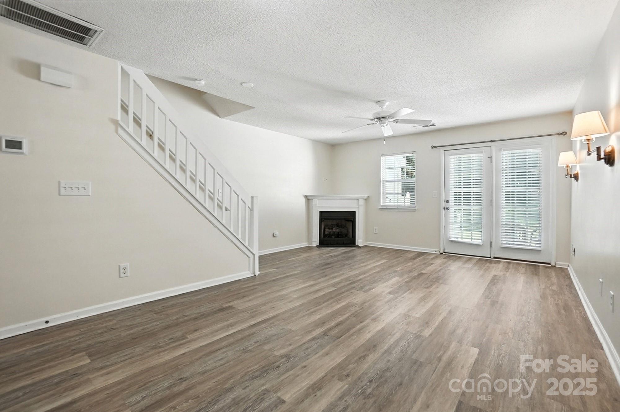 8130 Rudolph Road Charlotte, NC 28216 - Photo 29 of 36 a view of an empty room with wooden floor and a window