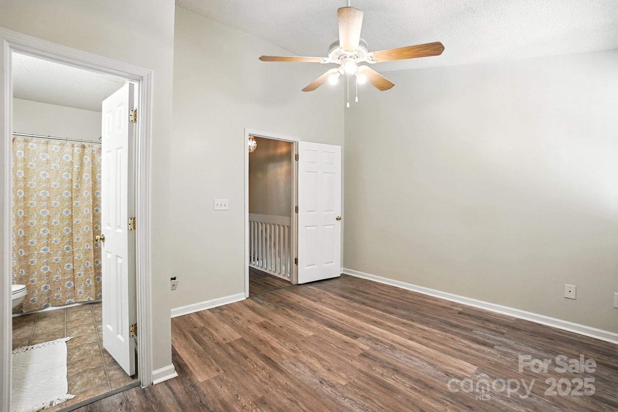 8130 Rudolph Road Charlotte, NC 28216 - Photo 33 of 36 a view of a room with wooden floor and a ceiling fan