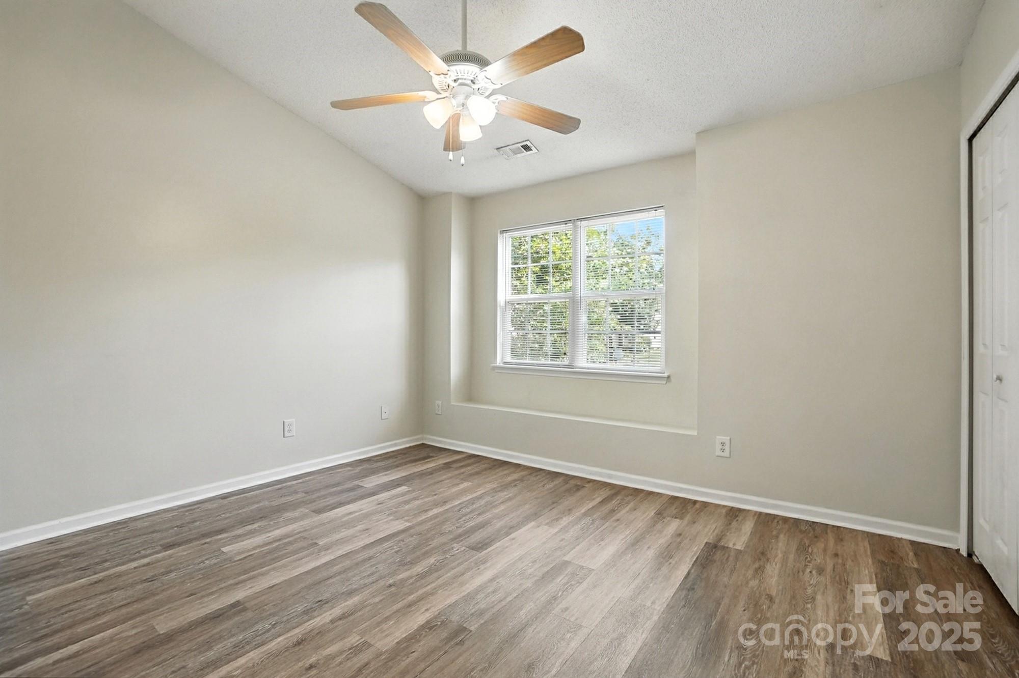 8130 Rudolph Road Charlotte, NC 28216 - Photo 35 of 36 wooden floor in an empty room with a window
