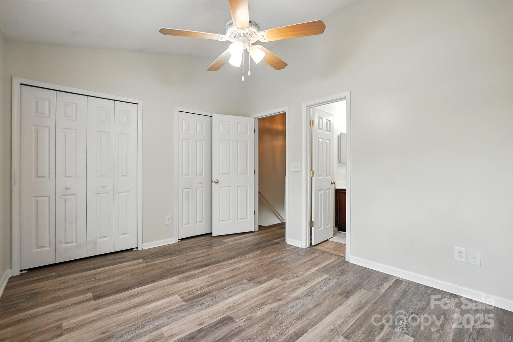 8130 Rudolph Road Charlotte, NC 28216 - Photo 36 of 36 an empty room with wooden floor and a ceiling fan