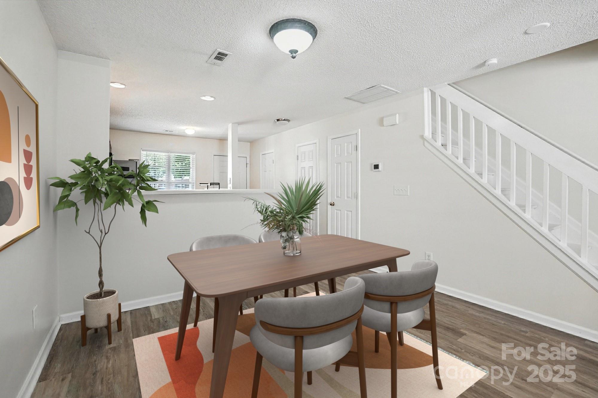 8130 Rudolph Road Charlotte, NC 28216 - Photo 6 of 36 a view of a dining room with furniture and wooden floor