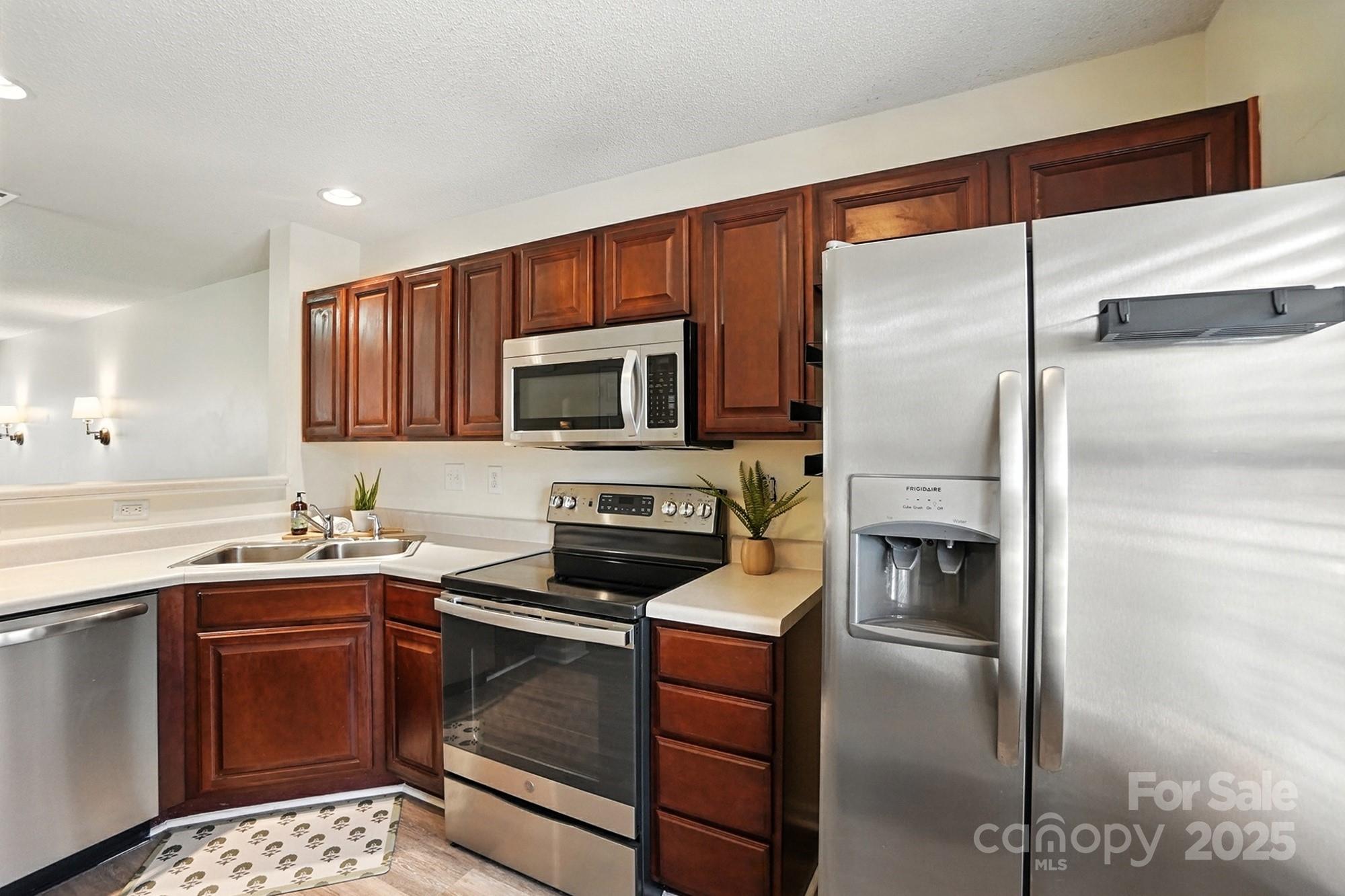 8130 Rudolph Road Charlotte, NC 28216 - Photo 9 of 36 a kitchen with a refrigerator sink and microwave