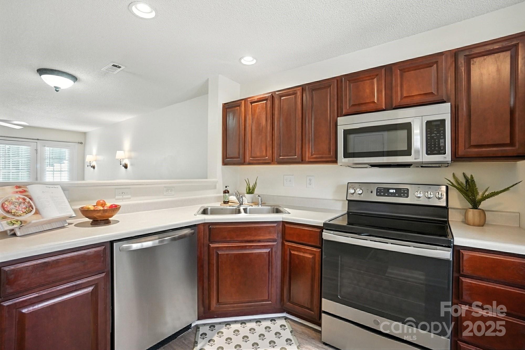 8130 Rudolph Road Charlotte, NC 28216 - Photo 10 of 36 a kitchen with a sink stove and microwave