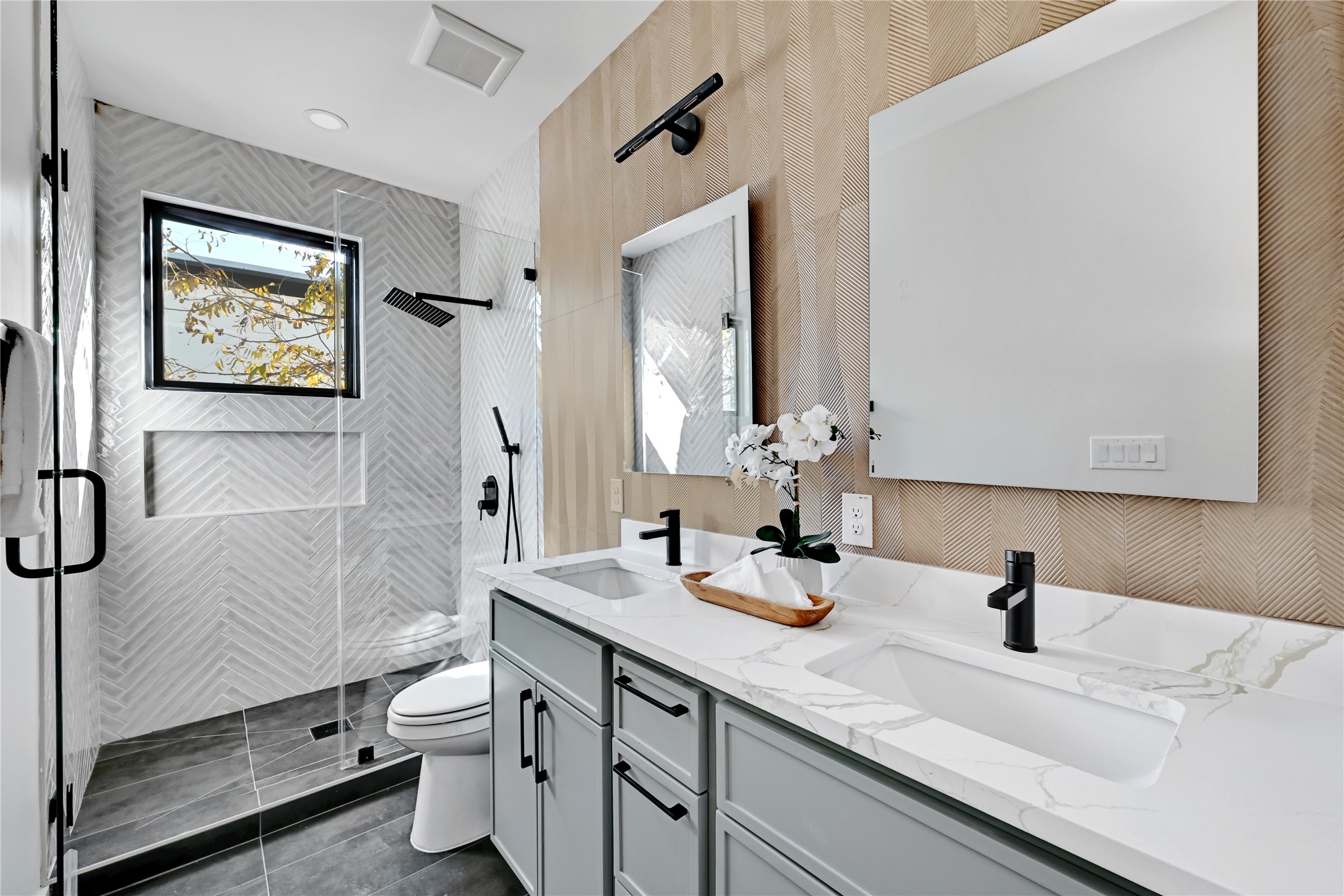 2717 Lyons Road, Unit 1 Austin, TX 78702 - Photo 20 of 34 Bathroom with a stall shower, double vanity, wallpapered walls, dark tile patterned flooring, and recessed lighting