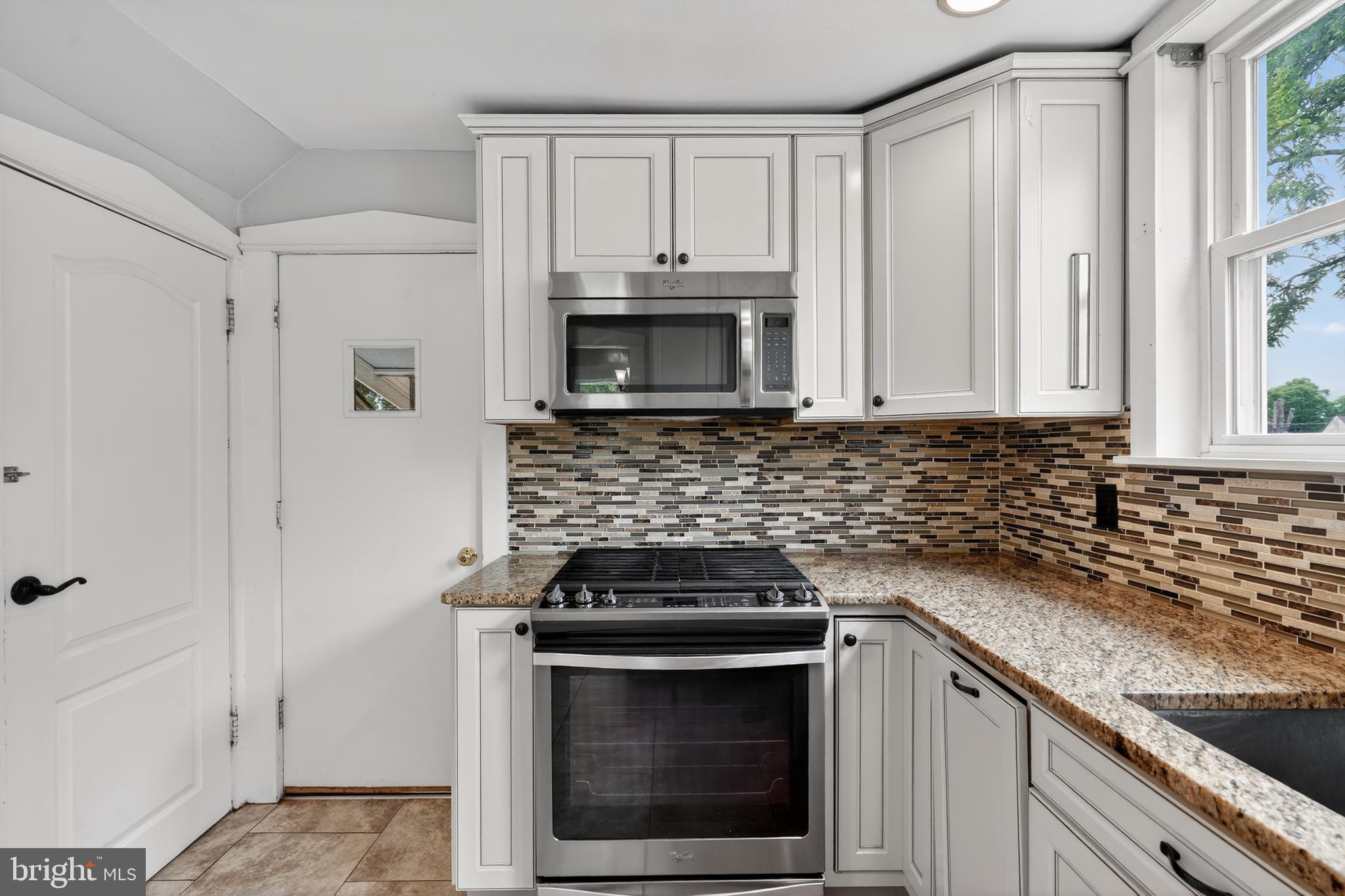 106 Ford Street Voorhees, NJ 08043 - Photo 15 of 36 a kitchen with granite countertop white cabinets and stainless steel appliances