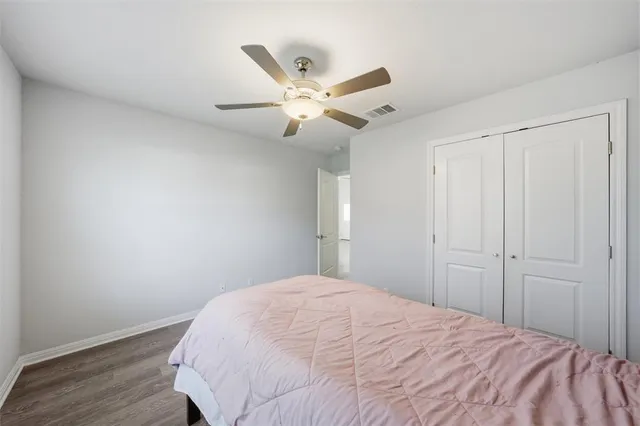 a bedroom with a bed and a ceiling fan