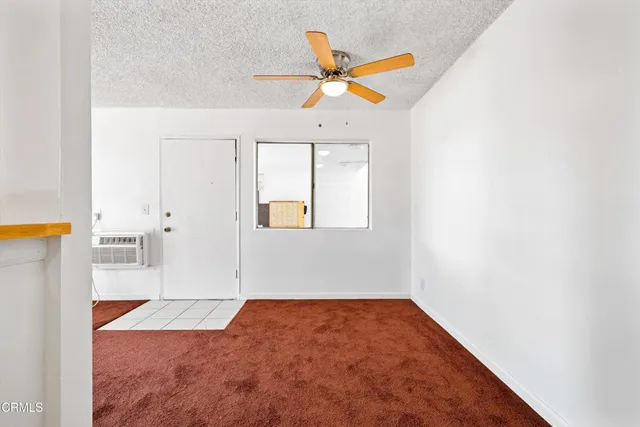 a kitchen with a sink a stove top oven and white cabinets