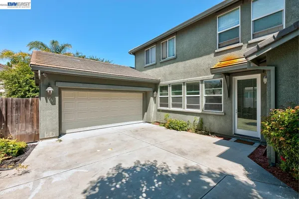 a view of a dining room with furniture a chandelier and wooden floor