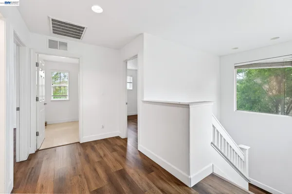 a white toilet sitting in a bathroom next to a window