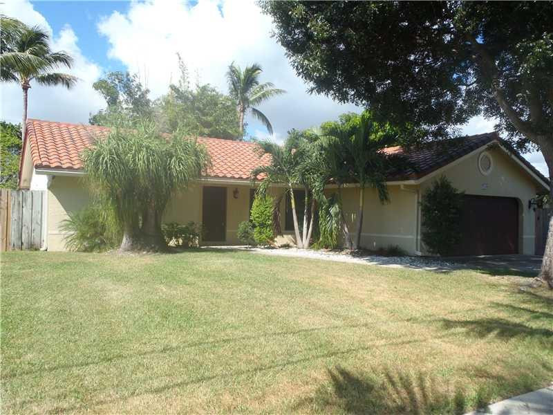 7589 Texas Trail Boca Raton, FL 33487 - Photo 1 of 13 a house with yard in front of it