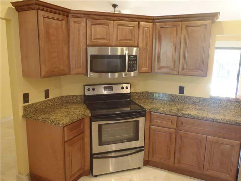 7589 Texas Trail Boca Raton, FL 33487 - Photo 7 of 13 a kitchen with granite countertop a sink and a stove