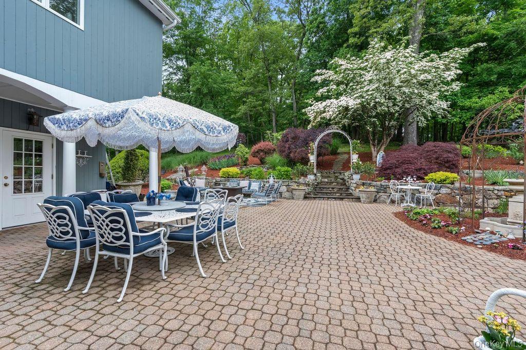 266 Shear Hill Road Mahopac, NY 10541 - Photo 20 of 34 a view of a patio with table and chairs under an umbrella