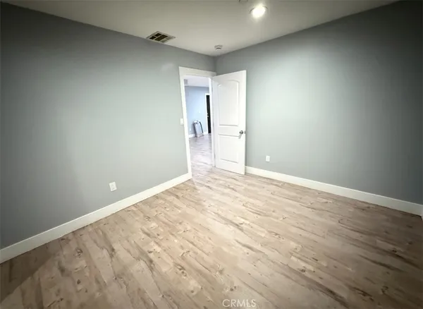 a kitchen with a refrigerator a stove top oven a sink and dishwasher with wooden floor