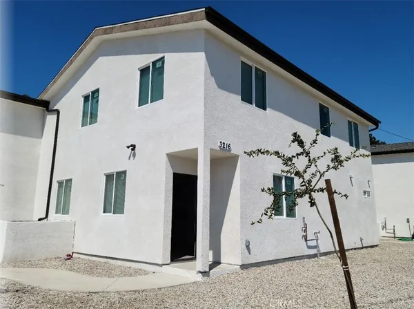 a kitchen with stainless steel appliances granite countertop a refrigerator a sink and a stove