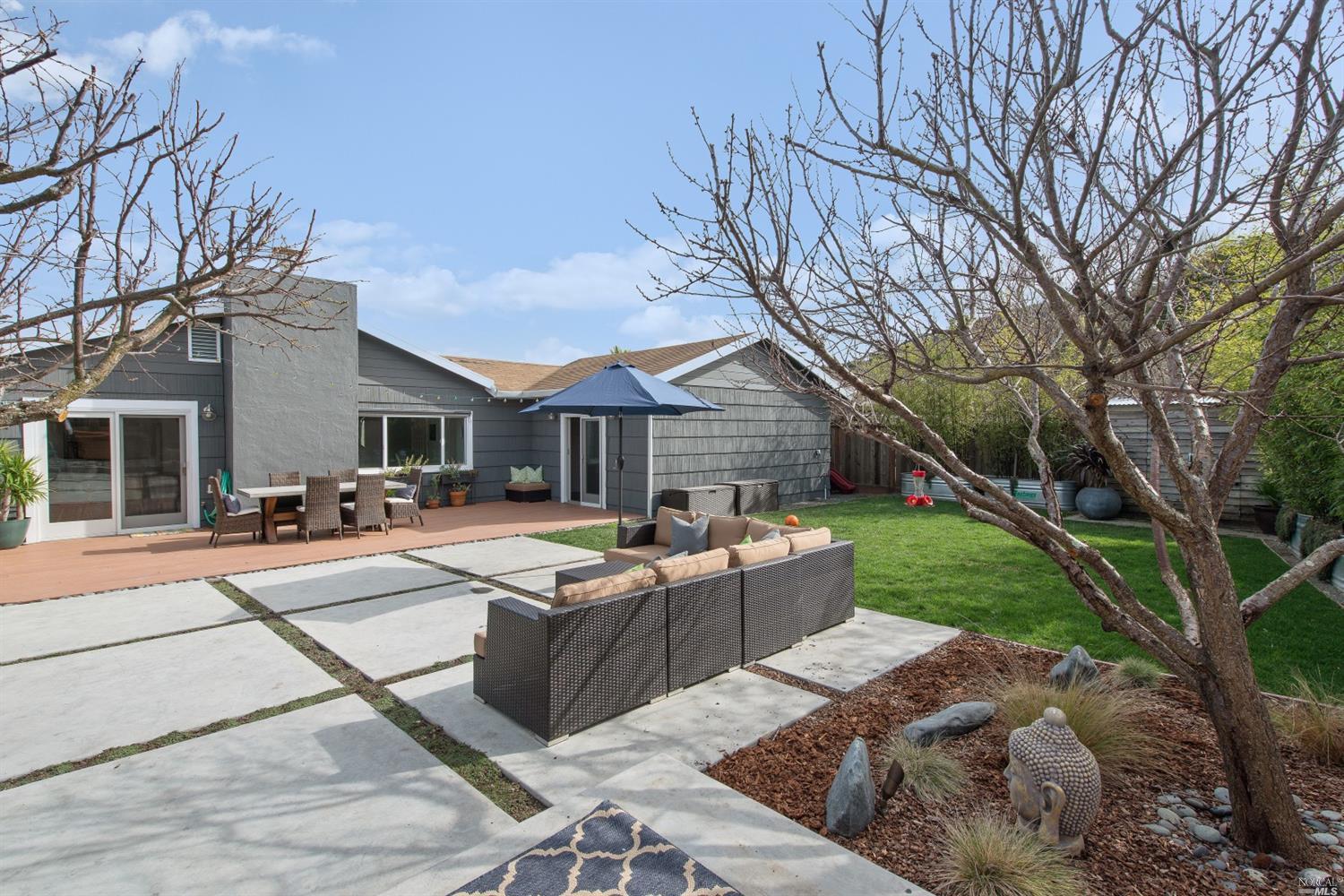 a front view of house with yard and outdoor seating