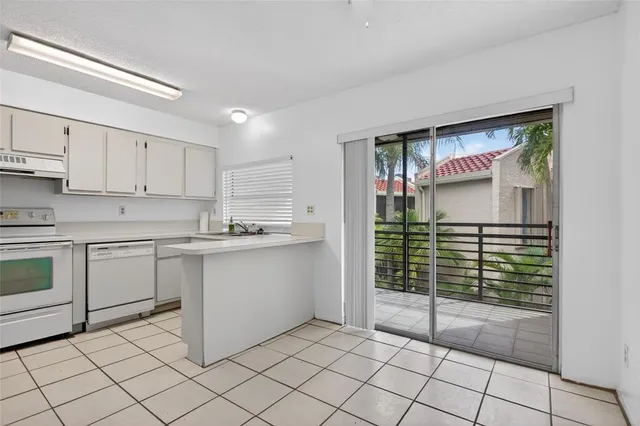 a kitchen with granite countertop a sink and a stove