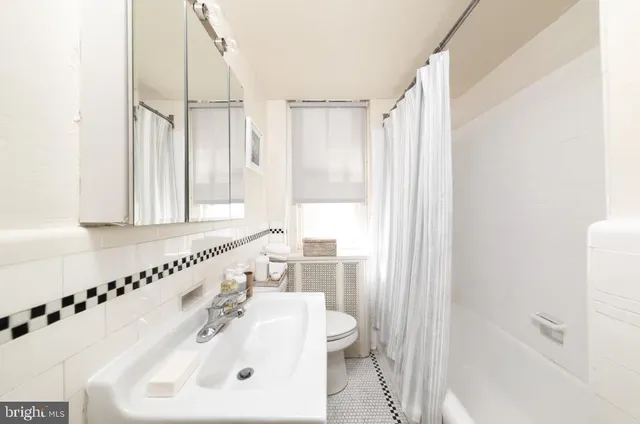 a bathroom with a sink a toilet and a bathtub