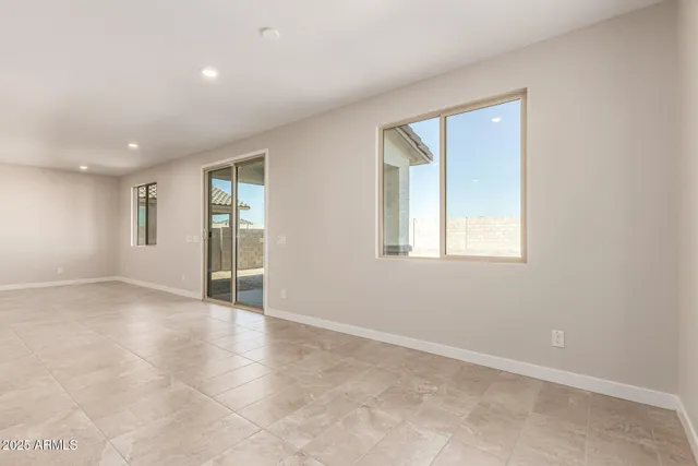 an empty room with windows and entrance