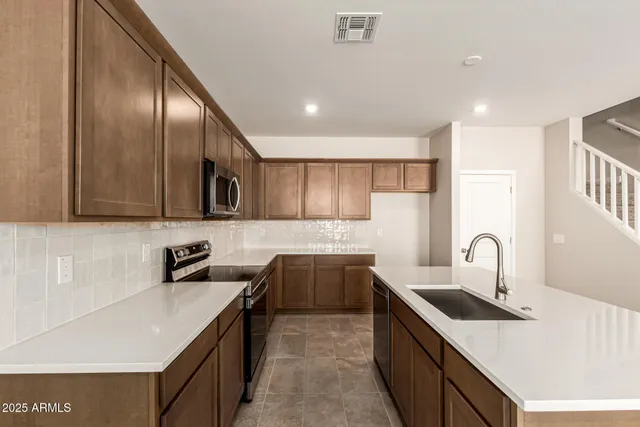 a kitchen with a sink stove and cabinets