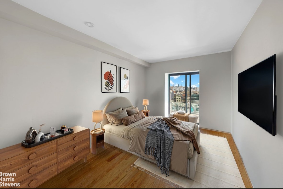 775 Lafayette Avenue, Unit 8B Brooklyn, NY 11221 - Photo 12 of 27 a bedroom with a bed and a flat screen tv