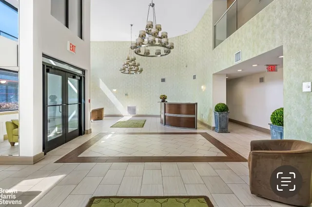 a living room with fireplace furniture and a chandelier