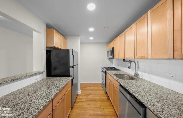 a kitchen with a refrigerator and a sink