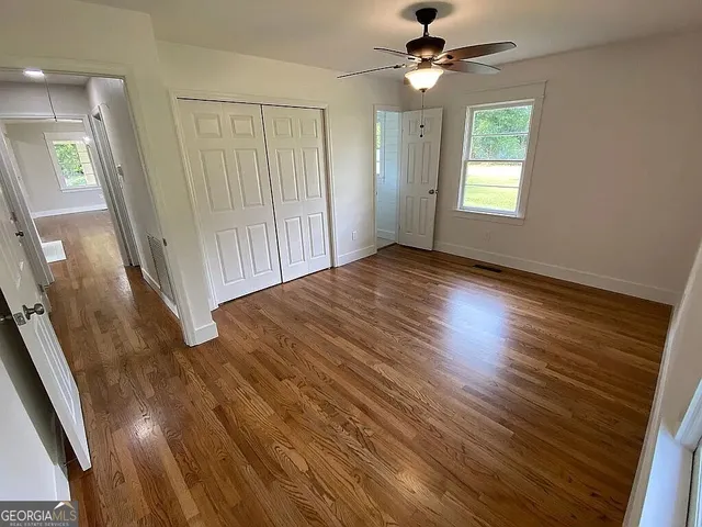 wooden floor in an empty room with a window