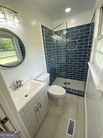 a bathroom with a toilet sink and shower