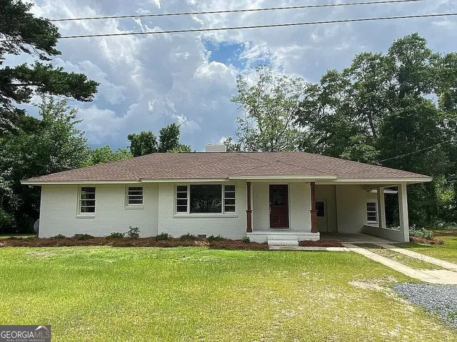 a view of a white house with a swimming pool