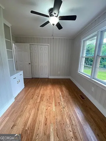 wooden floor in an empty room with a window