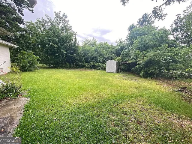 a view of a big yard with an outdoor space