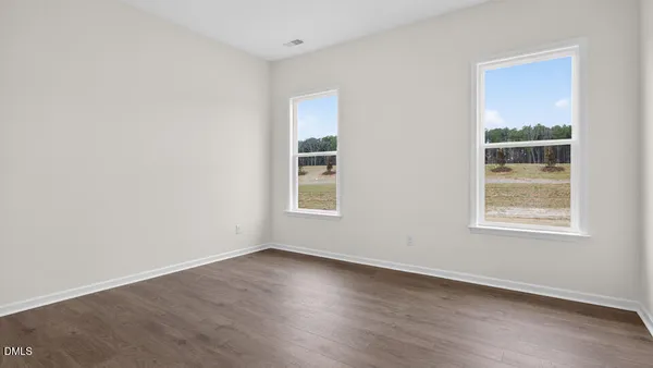 a view of a room with wooden floor
