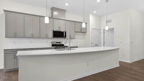 an empty room with wooden floor & closet and windows
