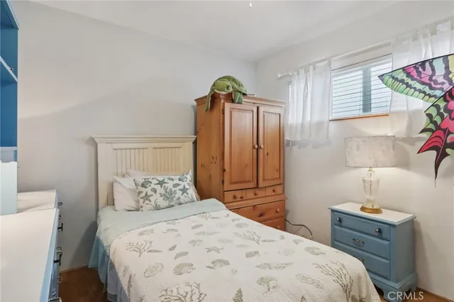 a bathroom with a sink mirror toilet and next to a window