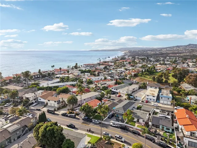 a view of a house with a small yard and wooden fence