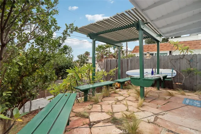 a vase of flowers besides of a table with six mirrors