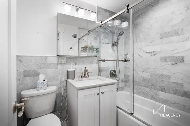 a bathroom with a sink toilet and shower