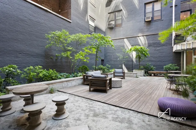 a view of a patio with chair and potted plants