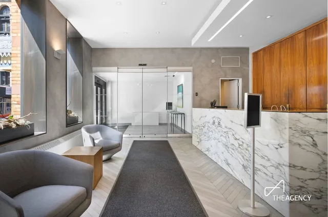 a spacious bedroom with a large bed couch and a window