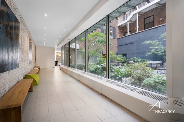 a swimming pool with large glass windows and painted walls