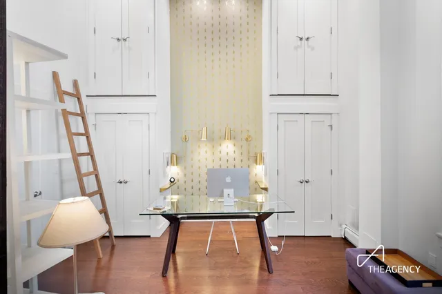a view of a room with wooden floor and white walls